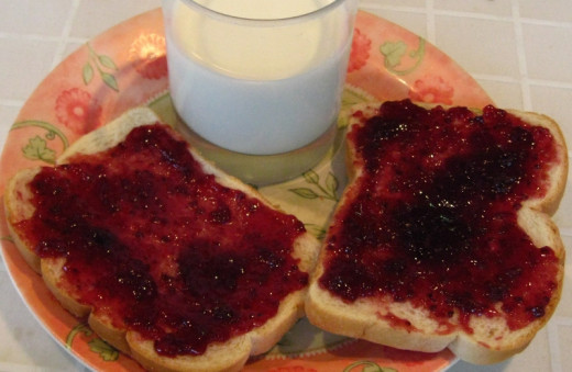 Toasted bread, butter and jam, or fruit spread.
