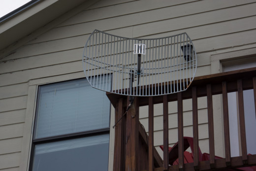 This photo shows a grid parabolic directional wireless internet antenna. 