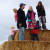 The kids climbed the huge straw mountain.