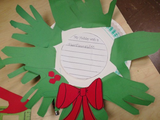 Put the final touches of the holiday wish, ribbon, and berries on the wreath.