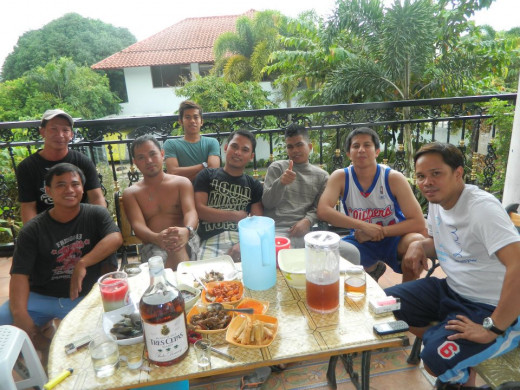 An inuman session. Guys with their liquors and egg rolls, mussels and some Filipino dishes for their pulutan which is roughly similar to finger food.