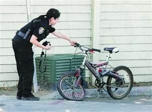 Police officer and damaged bicycle