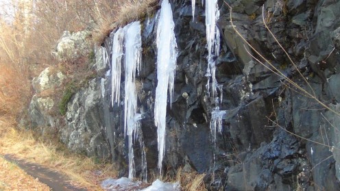 Ice sheets form as water runs off the rocky face of the mountain and temperatures dip below freezing at night. Even the relatively warm daytime temperatures cannot melt it all.