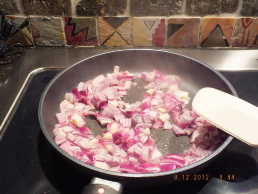 Cooking the onions and garlic until soft but not brown.