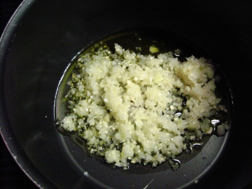 In a food processor, mince the onion, and garlic, than put them in a big non-stick pot with some EVOO, on medium heat.