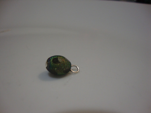 Large bead with curled bi-pin.