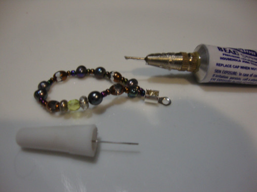 Crimped wire with cover.  Use glue to reinforce closure.