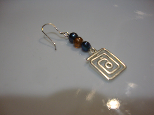 Wire with small beads atop cool charm.