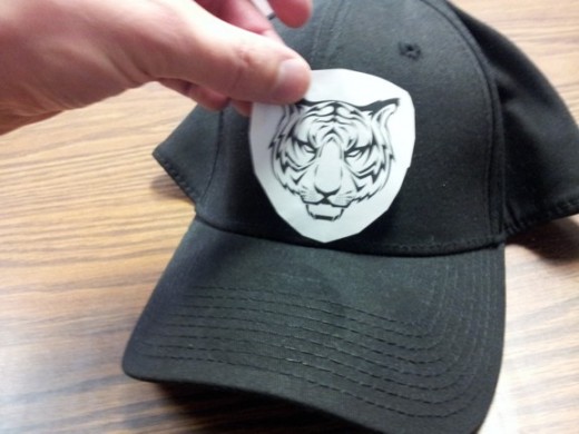 When in doubt, print your design on a piece of paper and put it next to a cap to help visualize if it will work or not when it is sewn.
