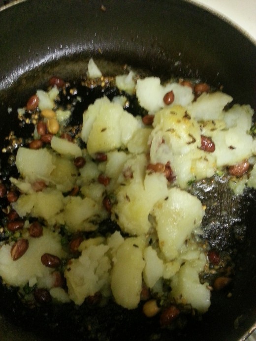 Add green chilli cumin seeds and potatoes
