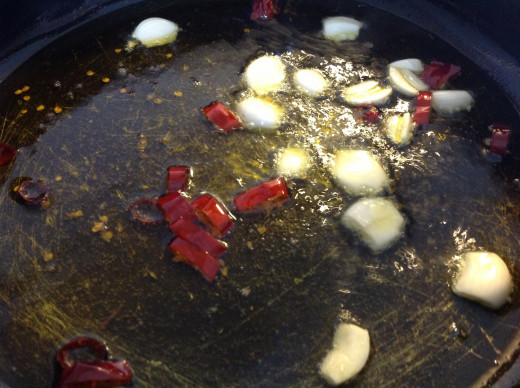 Chili and garlic frying in the pan of extra virgin olive oil