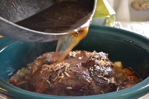 Pour broth and meat scrapings over the roast and into the slow cooker..