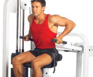 Man using the assisted chair dip exercise machine