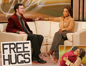 (This link is good) Juan Mann on Oprah TV Show/ He started the Free Hugs Campaign/Movement. See videos below. It took 15 minutes for him to get his first hug while holding the sign in public.
