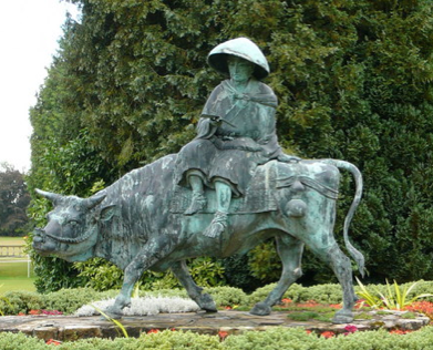 A statue depicting the Taoist sage Lao Tse mounted on a tamed wild ox, an allusion to gaining control over one's mind.  The ox-herding allusion was created by a Zen Buddhist Master in the 12th century.  