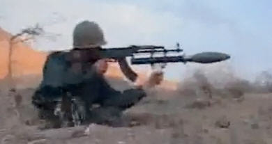 Iranian soldier firing a gas grenade