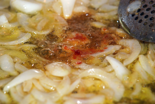 Onions cooking in sizzling cumin with a pinch of paprika added. (Photo by Shanti Perez)