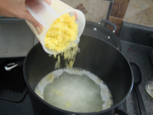 Pouring shredded Fels Naptha soap into boiling water