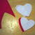 Cut one large heart from the felt that will be your back piece (in this case the white), and one smaller heart from the felt that will be the front piece of your project (in this case the red). Cut one large heart from the felt that will be your back piece (in this case the white), and one smaller heart from the felt that will be the front piece of your project (in this case the red).
