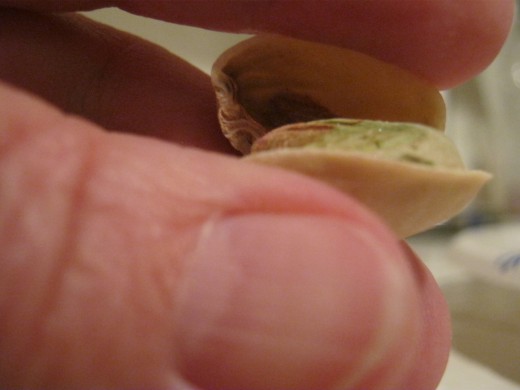 Twist it like you are twisting a screwdriver and hear the nut pop open. Easy! Now there's no reason to leave those partially opened difficult ones for someone else to deal with when you're eating pistachio's. Not that I ever did that...