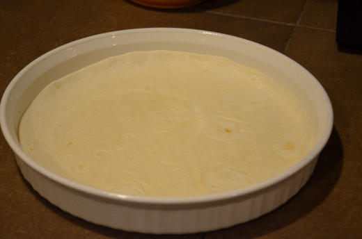 Line pie plate with one 8-inch tortilla.