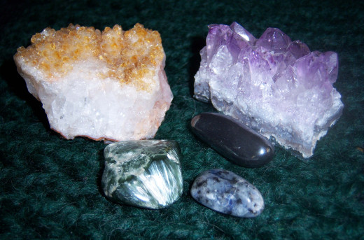 Clockwise, starting from the upper left corner: Citrine, Amethyst, Hematite, Soladite and Seriphanite. These were all purchased at various shops.