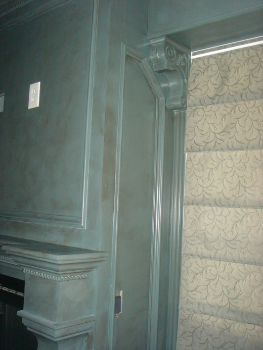 AFTER This closer view shows the antiquing on the unusual paint color and the detail of the corbels and braid woodwork.