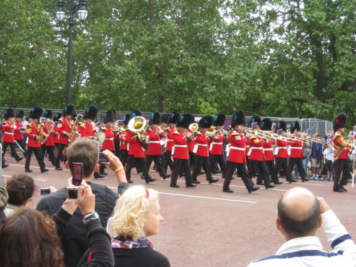 Don't go to Buckingham Palace, go to where they start their procession: a much better experience.  