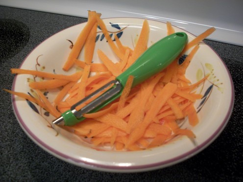 Step 3.  To make slivered carrots, take a vegetable peeler and start peeling away.