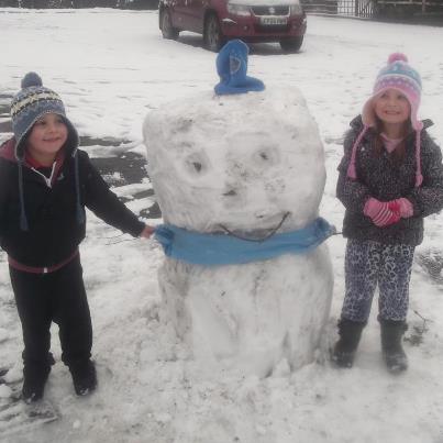 KRYSTAL AND RILEY PROUDLY SHOWING OFF THEIR SNOWMAN. 