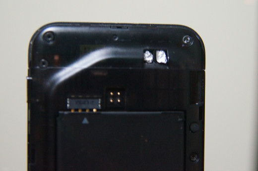 In the upper right corner of the phone you see two shiny spots. This is where I have placed some aluminum foil balls to help the antenna contacts connect to the antenna.  Add this to what is seen in the video below to increase reception.
