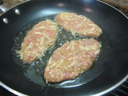 Heat ¼ cup oil in a large nonstick skillet over medium heat . Add the patties to the pan.