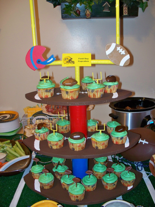 Football shaped cupcake tower loaded with cupcakes