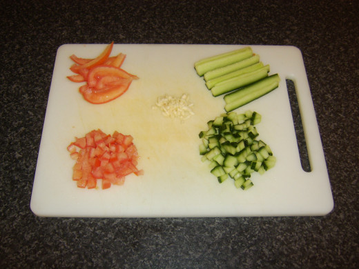 Chopping the cucumber salsa ingredients