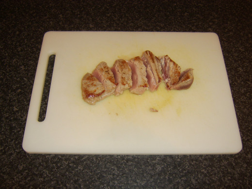 Tuna loin steak is sliced at an angle