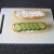 Cucumber slices are laid on top of the mayo on the bottom half of the sub