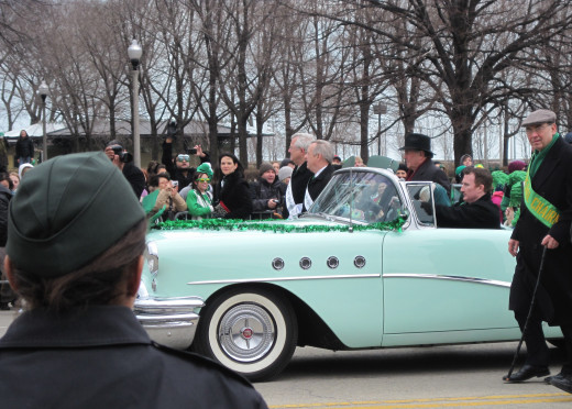 Mayor Daley and Senator Richard Durbin are seen walking here next to this convertible.