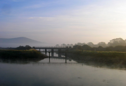 Confluence of the River Ouse and Glynde Reach. Mount Caburn can be seen in the background.