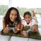 An attentive child play a video game