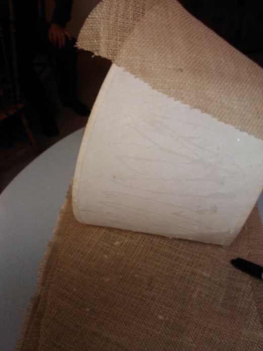 Roll the shade while marking fabric 1 inch wider to allow for folding over the framework.