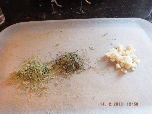 Hand crush the dried oregano and basil. It will release its oils. Mince the garlic.