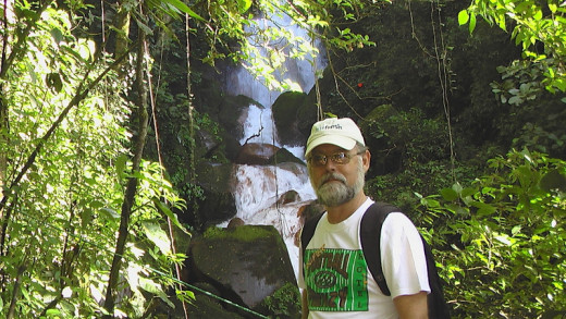 A water falls located on the southeast flank of Volcano Miravalles and yours truly.  There are old growth trees along the steep walk up to the falls.  We arrived at the base of the trail on a tractor-pulled cart.