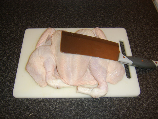 Flattening chicken with cleaver