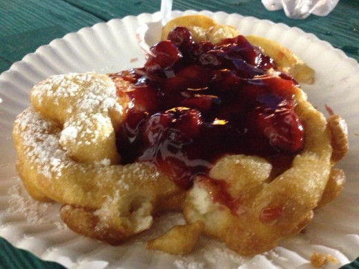 Don't forget the famous funnel cake.  This one topped with cherries and sprinkled with powdered sugar is to die for! 