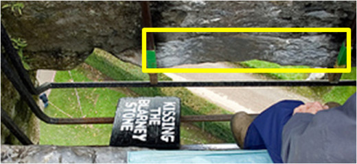 The real Blarney Stone is not a rock on the ground.  It is attached to Blarney Castle.