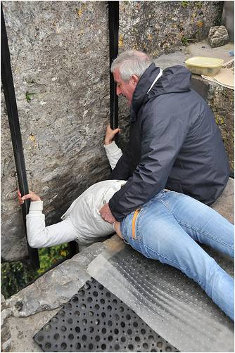Lean your head down and out under the parapet wall