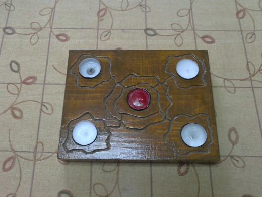 A handmade tealight holder in rectangle shape, with added engraving decorations