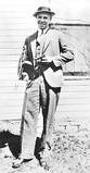 John Dillinger with Colt Thompson submachine gun and the wooden gun that got him out of prison