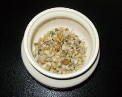 Another solution is to cover the bottom with a good layer of pebbles so that excess water has someplace to go.  If this method is used be very careful not to over water, which can rot your plant. 