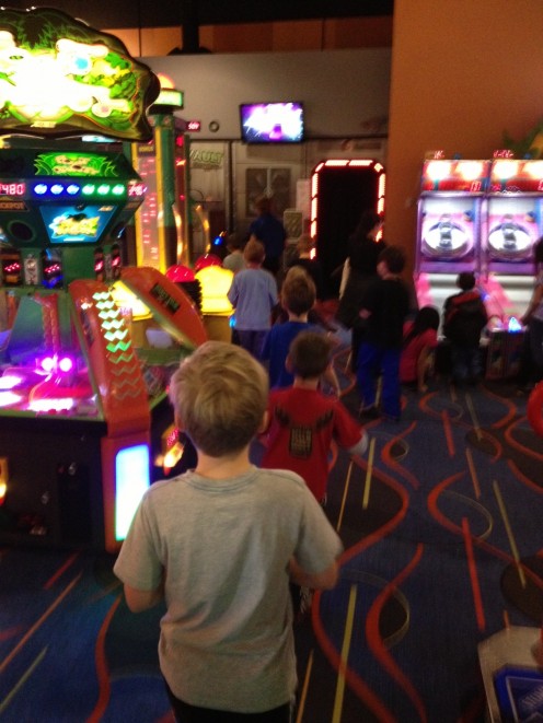 Kids in a row at arcade bowling birthday party